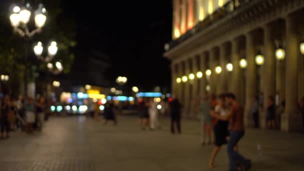 Young couple gracefully dances a ballroom dance on the square of paving slabs 4K — ストック動画