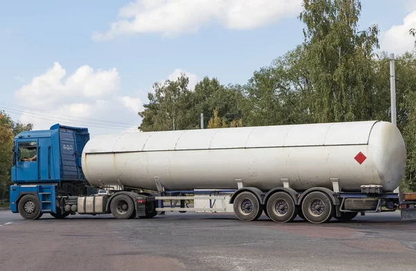 A gas tanker on a city highway