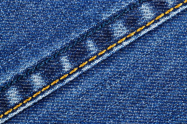 Blue denim with yellow thread — Stock Photo, Image