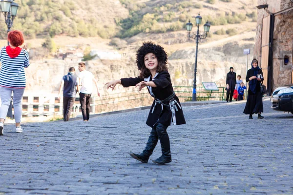 Cute little Georgian girl dressed in traditional clothes wearing
