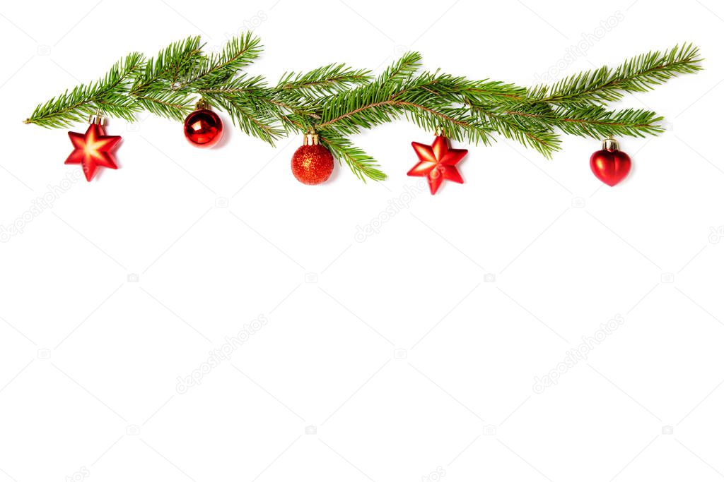 Red Christmas toys and sprigs of spruce on a white isolated background. Holiday card, copy space. Design elements. Christmas frame. 