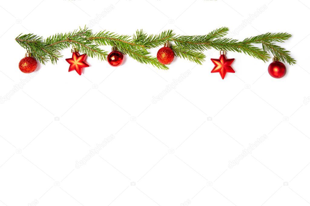 Red Christmas toys and sprigs of spruce on a white isolated background. Holiday card, copy space. Design elements. Christmas frame.