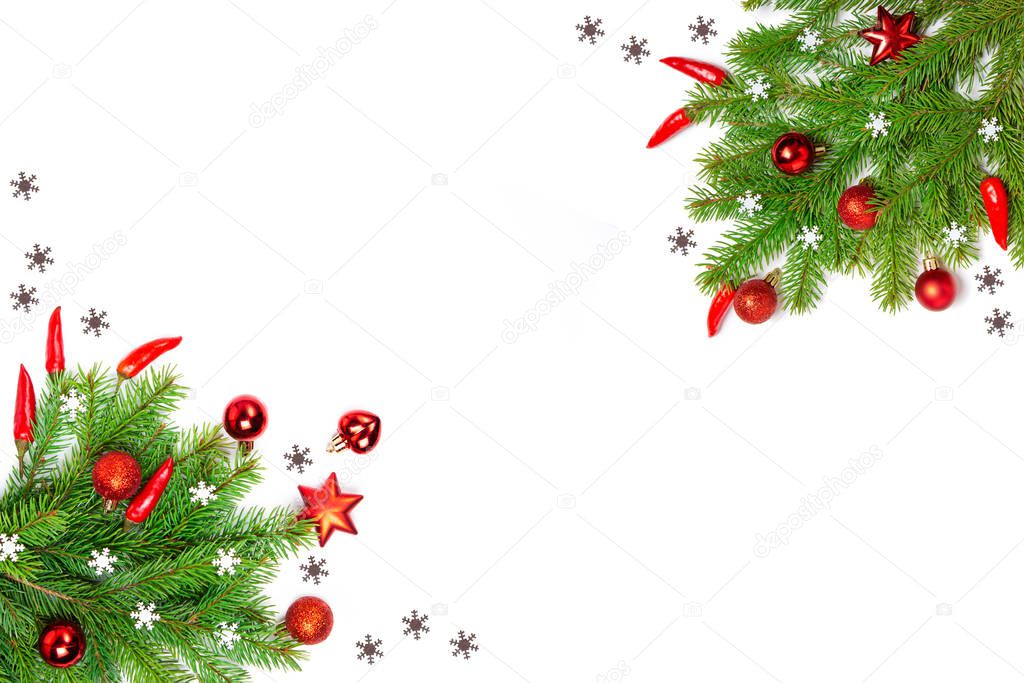 Christmas flatly copyspace. Red Christmas ornament, spicy pepper and sprigs of spruce on a white isolated background. Design elements. Christmas frame.
