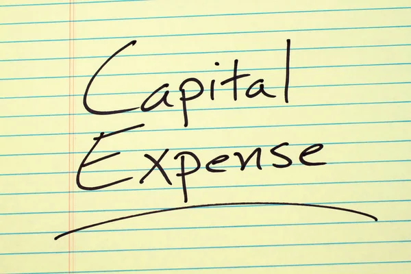 Kapitalkostnaden på en gul anteckningsblock — Stockfoto