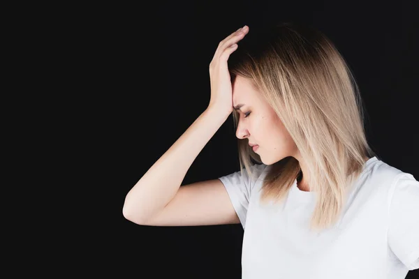 Portrait of a girl who holds on to the head with hands experiencing pain. — Stock Photo, Image