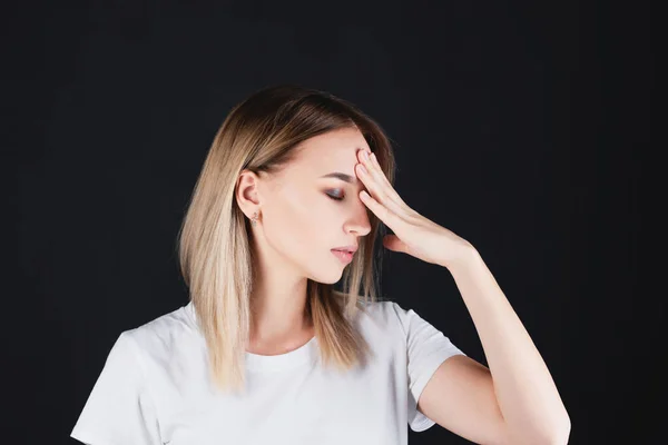 Portrait of a girl who holds on to the head with hands experiencing pain. — Stock Photo, Image