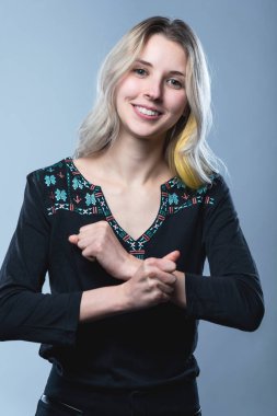 Closeup portrait of a girl, on an isolated gray background. Human face expression, emotions, feeling attitude reaction
