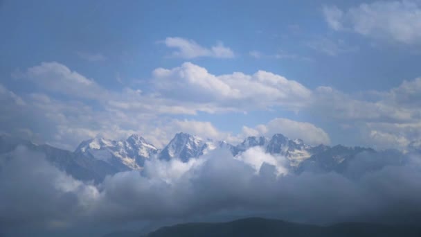 Zimowy krajobraz gór ze śniegiem pod błękitnym zachmurzonym niebem. Nagranie szybko poruszających się chmur — Wideo stockowe