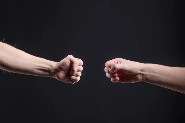 Mens hands on a dark background, show a game of stone, scissors, paper. The concept of confrontation and rivalry, games — Stock Photo, Image