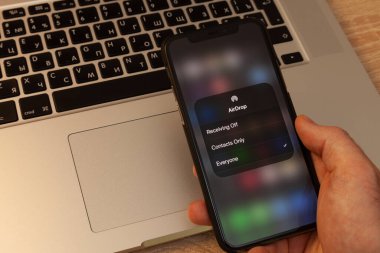 Moskova / Rusya - 18 Mayıs 2020: Siyah iPhone 11 Pro, MacBook klavye arka planında. Hava indirme ekranında.