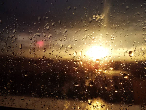 Rain drops on window with sun set — Stock Photo, Image
