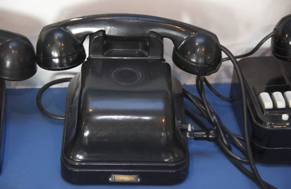 Black antique telephone. Vintage old telephone on desk.