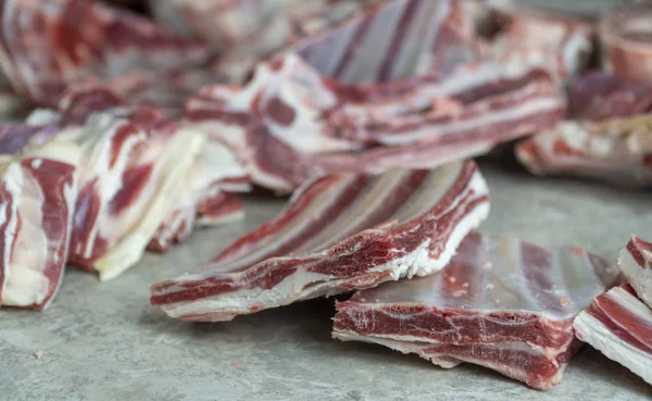 fat mutton meat, sliced pieces. the meat is on the table, ready to cook