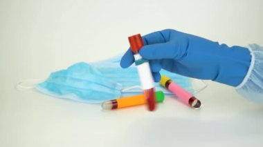 Hand holding blood sample in vacuum tube. Positive test result for the rapidly spreading Coronavirus, originating in Wuhan, China. New type virus 2019-n CoV. MERS chinese infection, atypical pneumonia