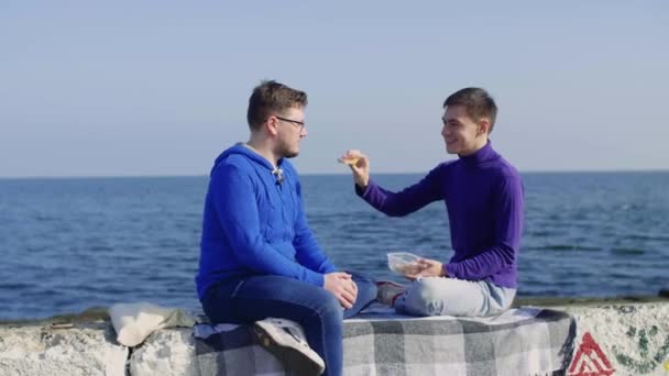 Two gay sit at sea — Stock Video