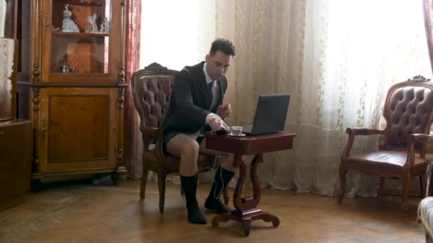 Businessman working at home without pants — Stock Video