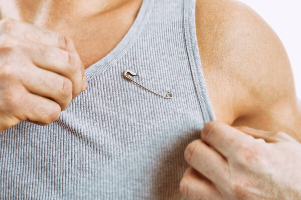 Man wearing a safety pin as a symbol of solidarity