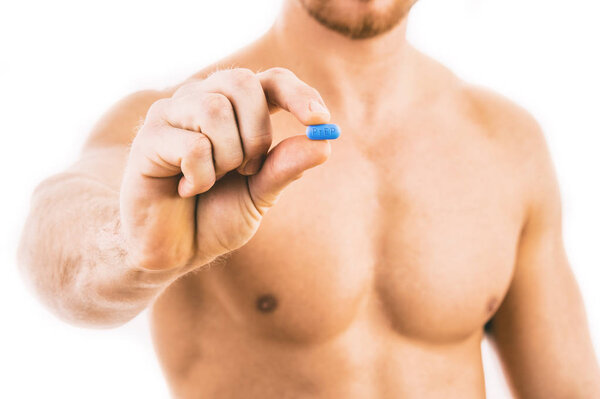 Man holding a pill used for Pre-Exposure Prophylaxis (PrEP)