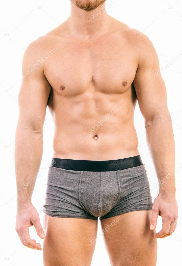 Muscular young man wearing boxer briefs isolated on white backgr