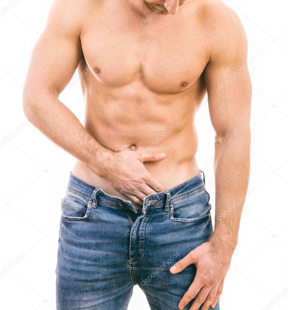 Muscular young man wearing jeans Isolated on white background.