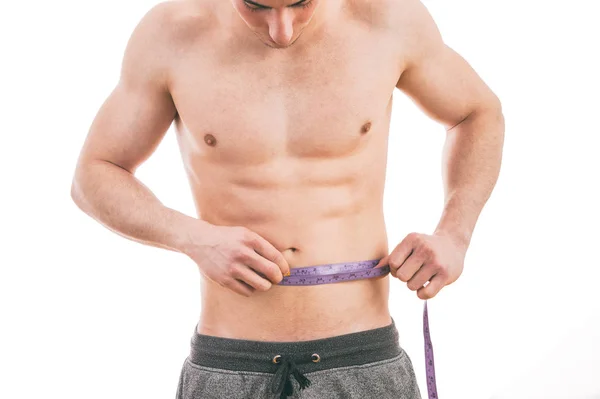 Male torso and blue tape measure on white background — Stock Photo, Image