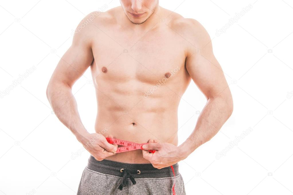 Male torso and red tape measure on white background
