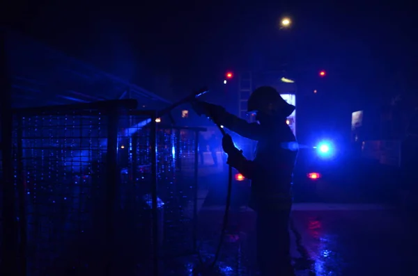 Stock image Berlin, Germany, 6th May 2019: Fire engine with flashing blue lights during fire fighting operations at night time