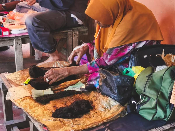 Mulher não identificada vende folhas de tabaco tradicionais em uma manhã — Fotografia de Stock