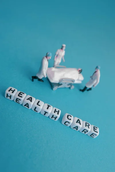 Miniature Medical Toy People Health Care Sentences Blue Teal Background — Stock Photo, Image