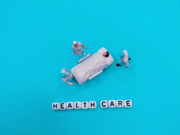 Miniature Medical Toy People Health Care Sentences Blue Teal Background — Stock Photo, Image