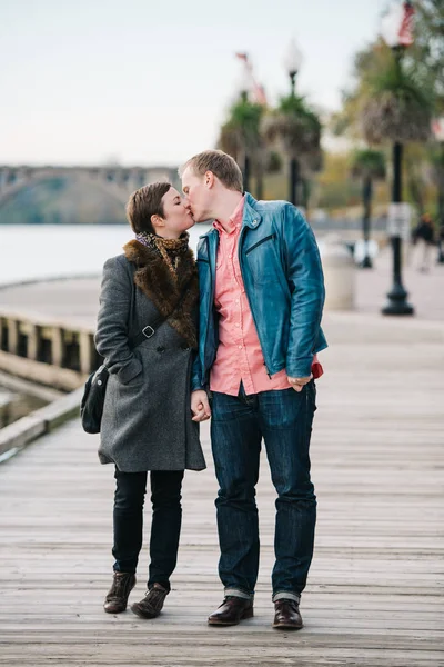 Caucasian Couple Walking Alongside Riverside Boardwalk Stop Kiss — Stock Photo, Image