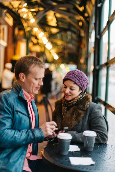 Attractive Caucasian Couple Sitting Cafe Drinking Coffee Using Handheld Smartphone — Stock Photo, Image