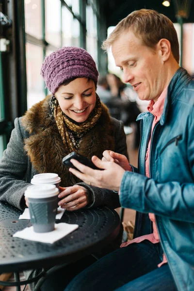 Attractive Caucasian Couple Sitting Cafe Drinking Coffee Using Handheld Smartphone — стокове фото