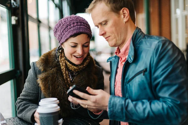 Attractive Caucasian Couple Sitting Cafe Drinking Coffee Using Handheld Smartphone — Stock Photo, Image