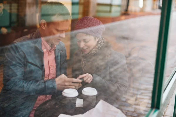 Attractive Caucasian Couple Sitting Cafe Drinking Coffee Using Handheld Smartphone — ストック写真