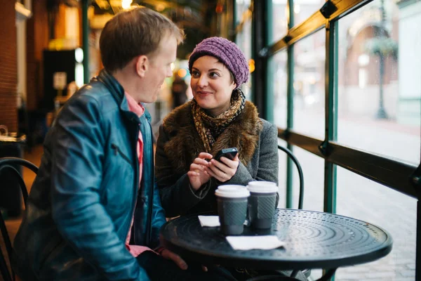 Attractive Caucasian Couple Sitting Cafe Drinking Coffee Using Handheld Smartphone — Stock Photo, Image