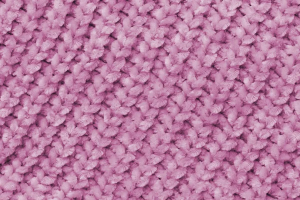 Fluffy soft pink fabric with waves and folds. Soft pastel textile texture. Folds on a soft cloth.