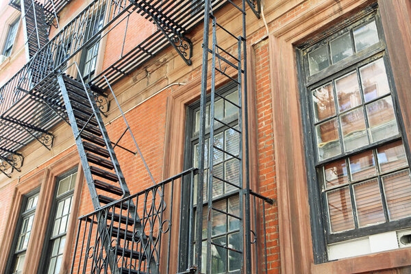 Escape stairs on buildings wall in New York City