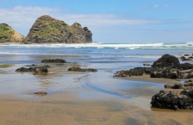 Volkanik kayalar üzerinde Piha Beach, Yeni Zelanda