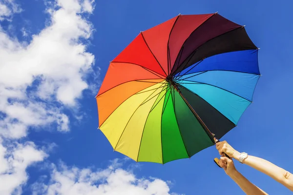 Multi-colored umbrella on the sky background — Stock Photo, Image