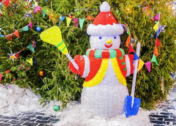 Snowman under tree with toy ornaments and lights — Stock Photo, Image