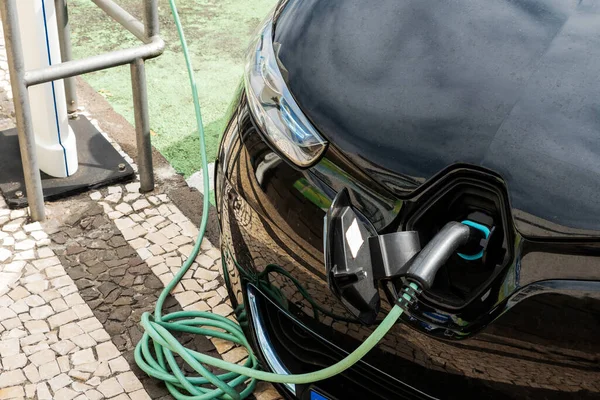 A fragment of an electric car at a fast-charging gas station. Selective focus.