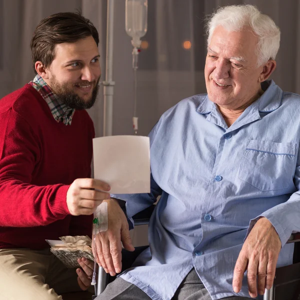 Son visiting disabled father — Stock Photo, Image