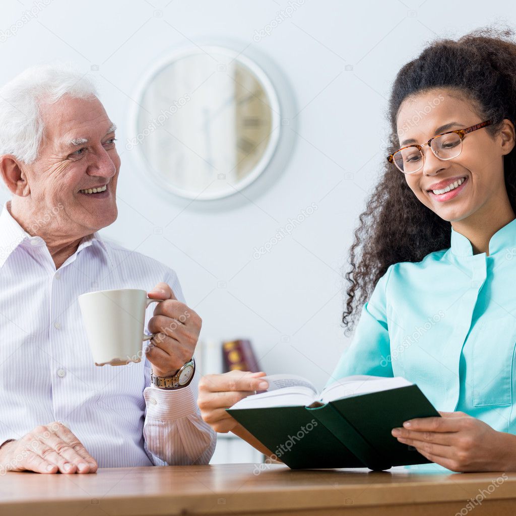 Nurse helping to read a book