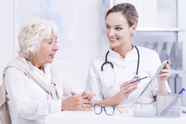 Doctor  talking with the senior woman clipart