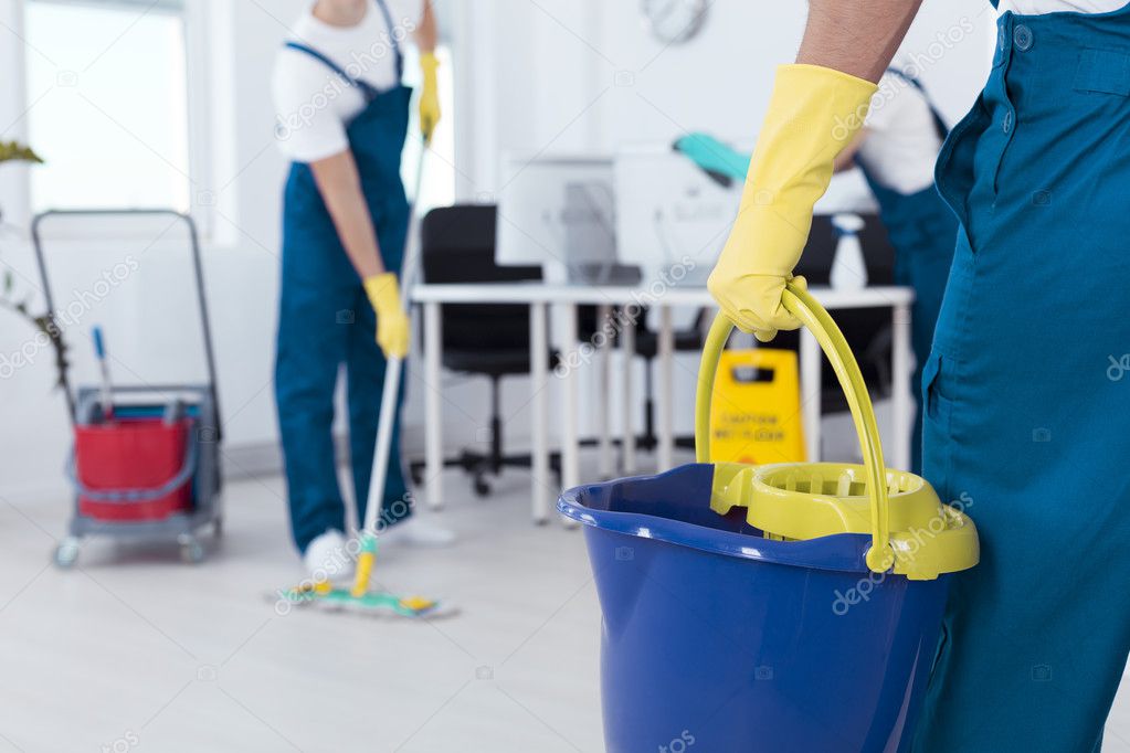 Man holding mop bucket