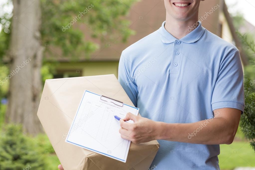 Happy courier holding a package