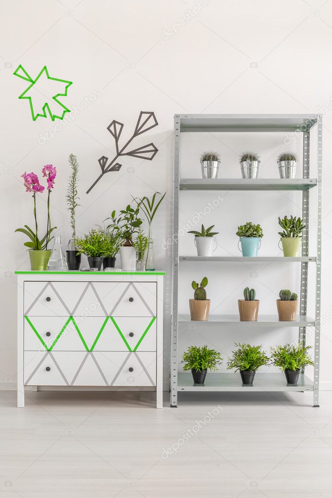 White commode and rack with plants