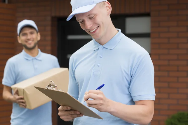 Delivery man with a package — Stock Photo, Image