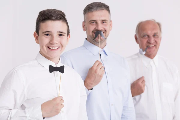 Three generation of man with paper attributes — Stock Photo, Image